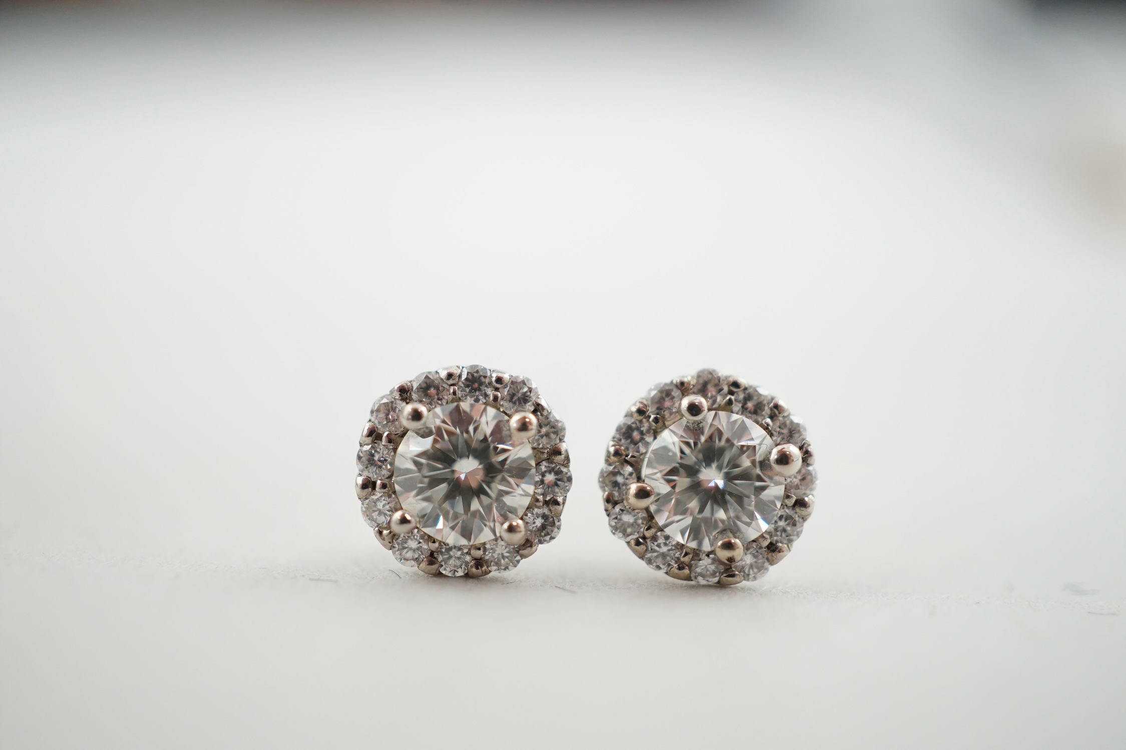 A modern pair of 18ct white gold and diamond cluster set ear studs